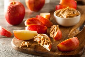 "Slices of fresh apples, bananas, or pears paired with a dollop of creamy nut butter, offering a wholesome combination of fiber, vitamins, healthy fats, and protein."