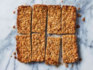 Homemade granola bars made with oats, nuts, seeds, dried fruit, and a touch of honey or maple syrup, offering a fiber-rich, protein-packed snack for kids on the go."