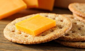 "A small portion of cheese paired with whole grain crackers, delivering a balanced snack rich in protein, fiber, and healthy carbohydrates to keep kids energized and satisfied."